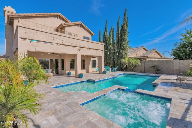 view of pool with an in ground hot tub and a patio area