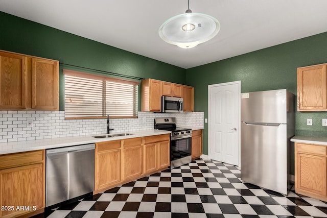 3235 S Bowman Rd, Apache Junction, AZ 85119 - kitchen featuring stainless steel appliances, a sink, dark floors, decorative backsplash, and light countertops