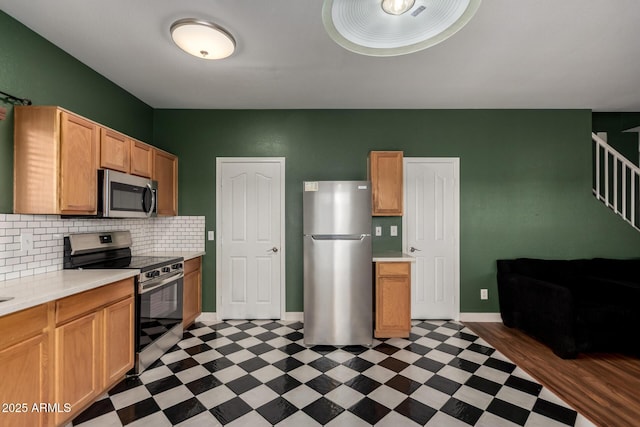 3235 S Bowman Rd, Apache Junction, AZ 85119 - kitchen with stainless steel appliances, light floors, light countertops, baseboards, and decorative backsplash