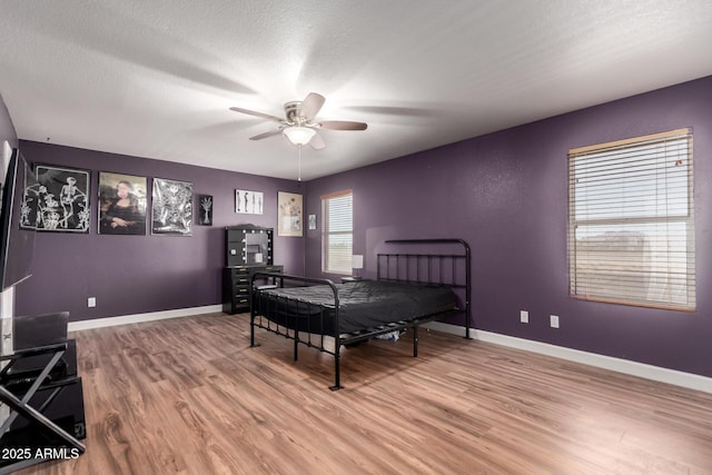 3235 S Bowman Rd, Apache Junction, AZ 85119 - bedroom with light wood finished floors, baseboards, a textured ceiling, and ceiling fan