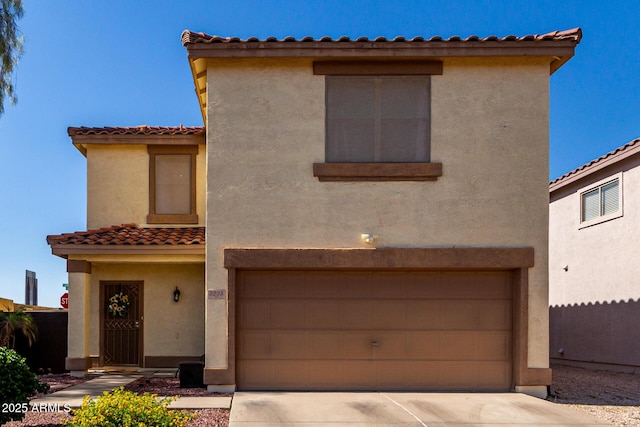 3235 S Bowman Rd, Apache Junction, AZ 85119 - mediterranean / spanish-style home with a tiled roof, stucco siding, concrete driveway, and a garage