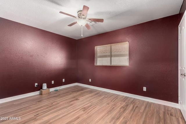3235 S Bowman Rd, Apache Junction, AZ 85119 - unfurnished room featuring wood finished floors, ceiling fan, a textured wall, and baseboards