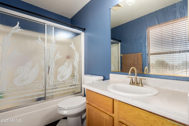 3235 S Bowman Rd, Apache Junction, AZ 85119 - full bath featuring vanity, toilet, and shower / bath combination with glass door