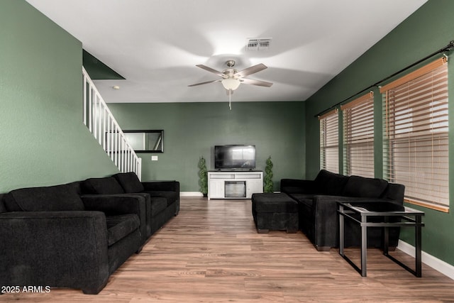 3235 S Bowman Rd, Apache Junction, AZ 85119 - living room featuring stairway, baseboards, ceiling fan, and wood finished floors