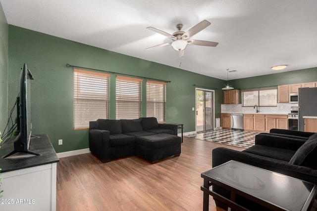 3235 S Bowman Rd, Apache Junction, AZ 85119 - living room featuring baseboards, light wood-style flooring, and ceiling fan
