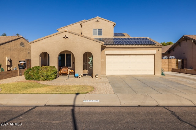 mediterranean / spanish-style home with solar panels