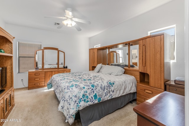 bedroom with light carpet and ceiling fan