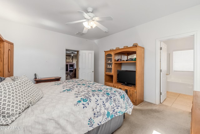 carpeted bedroom featuring ensuite bath and ceiling fan