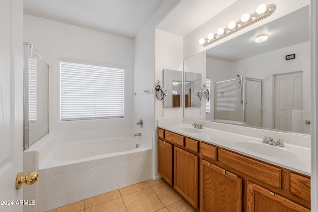 bathroom featuring tile patterned flooring, vanity, and separate shower and tub