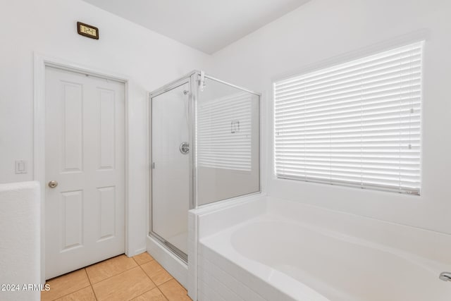 bathroom with separate shower and tub and tile patterned flooring