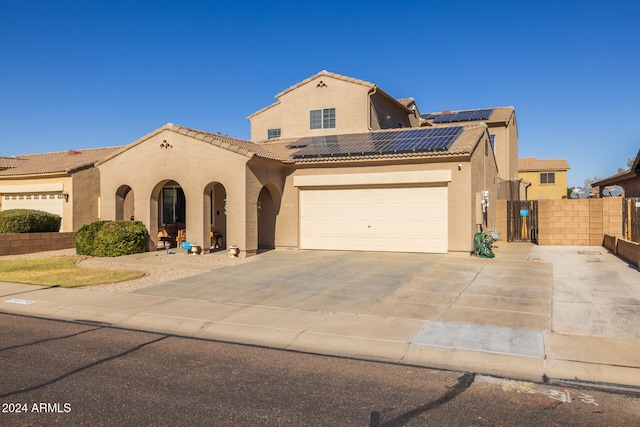 mediterranean / spanish home featuring solar panels