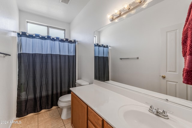 bathroom featuring tile patterned floors, a shower with curtain, vanity, and toilet