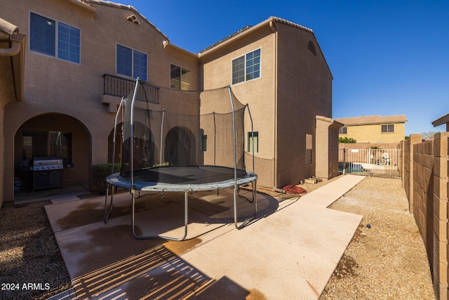 back of house featuring a trampoline