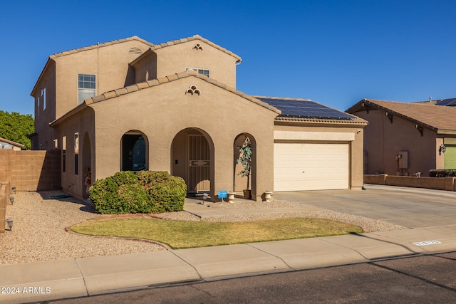 mediterranean / spanish-style home with solar panels