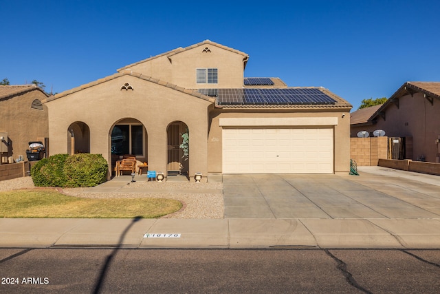 mediterranean / spanish house featuring solar panels