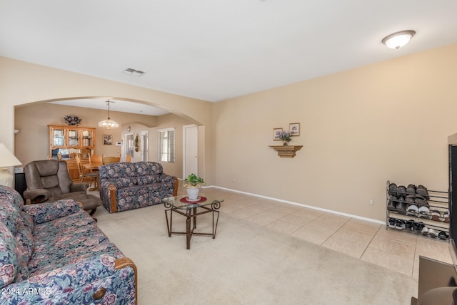 living room featuring light tile patterned floors and a notable chandelier