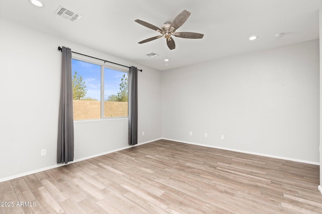 empty room featuring light hardwood / wood-style flooring and ceiling fan