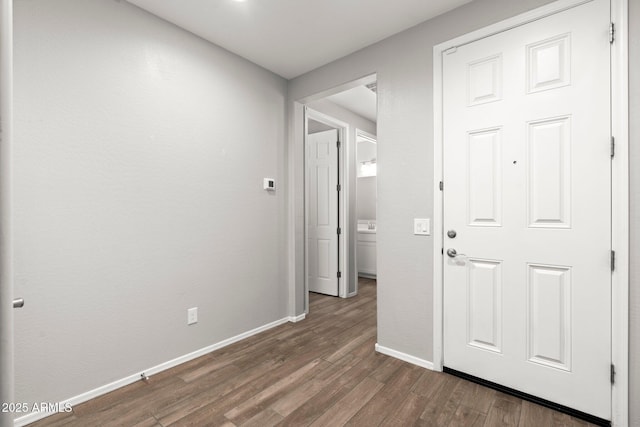 corridor with dark hardwood / wood-style flooring