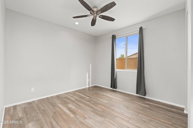 empty room with ceiling fan and light wood-type flooring