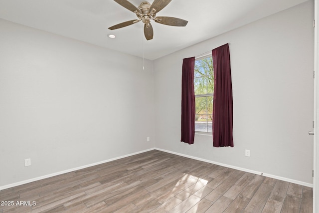 empty room featuring hardwood / wood-style floors and ceiling fan