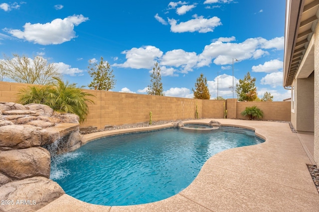 view of pool featuring an in ground hot tub, pool water feature, and a patio area