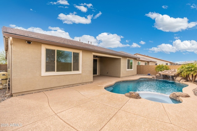 view of swimming pool featuring a patio, pool water feature, and an in ground hot tub