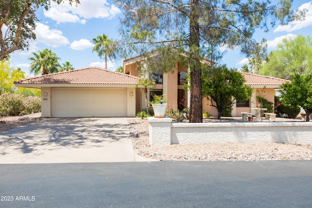 mediterranean / spanish home featuring a garage