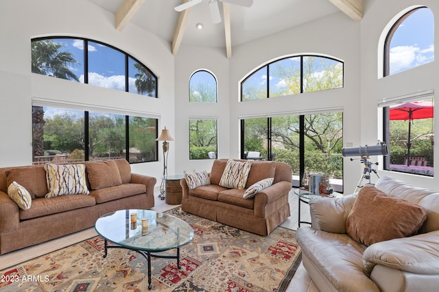 living room featuring high vaulted ceiling, ceiling fan, and a wealth of natural light