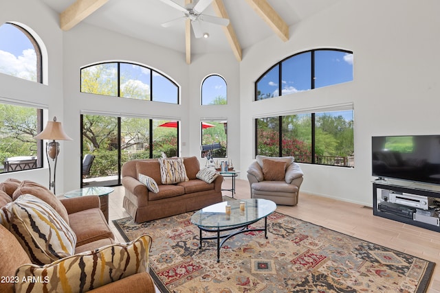 living room with plenty of natural light, high vaulted ceiling, ceiling fan, and light wood-type flooring