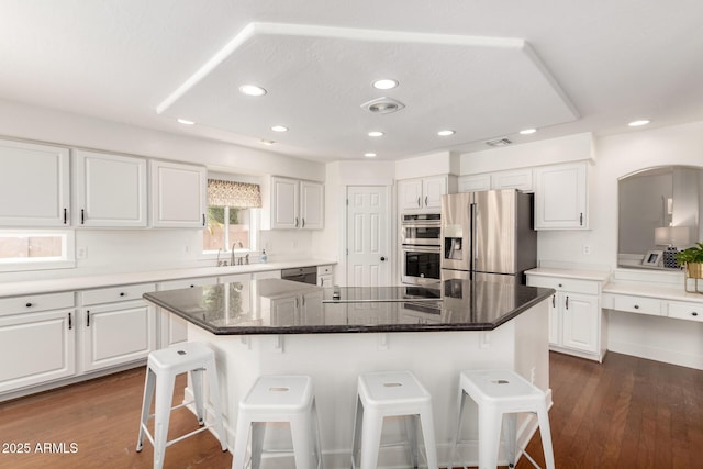 3772 E Leah Ln, Gilbert, AZ 85234 - kitchen with appliances with stainless steel finishes, a breakfast bar, recessed lighting, white cabinets, and dark wood-style floors