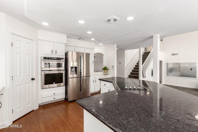 3772 E Leah Ln, Gilbert, AZ 85234 - kitchen with appliances with stainless steel finishes, white cabinetry, recessed lighting, dark wood-style flooring, and dark stone countertops