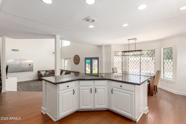 3772 E Leah Ln, Gilbert, AZ 85234 - kitchen with open floor plan, dark countertops, white cabinets, recessed lighting, and dark wood-type flooring