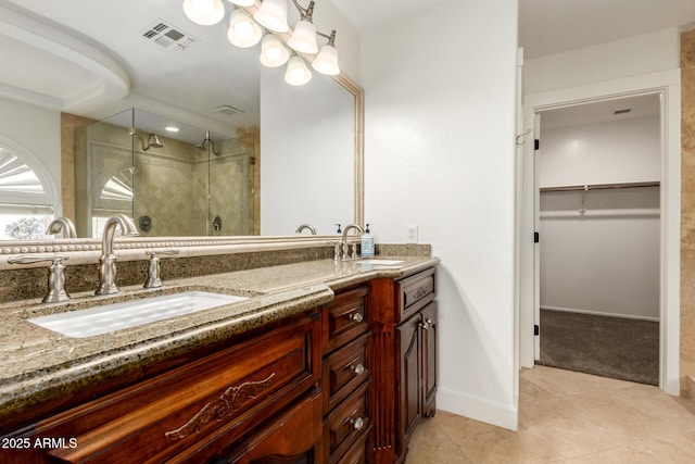 3772 E Leah Ln, Gilbert, AZ 85234 - bathroom with double vanity, a stall shower, a spacious closet, and tile patterned floors