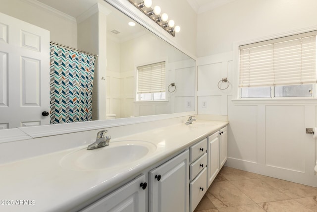 3772 E Leah Ln, Gilbert, AZ 85234 - bathroom with double vanity, ornamental molding, a decorative wall, tile patterned flooring, and wainscoting
