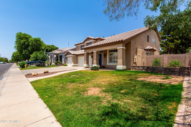 3772 E Leah Ln, Gilbert, AZ 85234 - mediterranean / spanish home with concrete driveway, a tiled roof, stucco siding, a garage, and covered porch