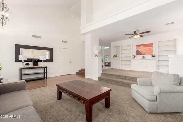 3772 E Leah Ln, Gilbert, AZ 85234 - living room with a ceiling fan, built in features, stairway, wood finished floors, and high vaulted ceiling
