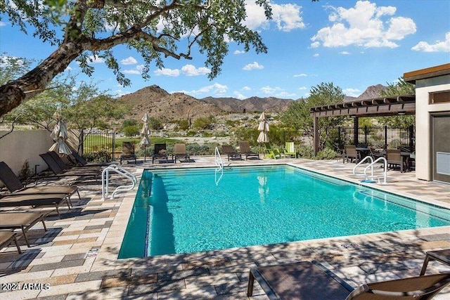 view of swimming pool featuring a pergola, a mountain view, and a patio