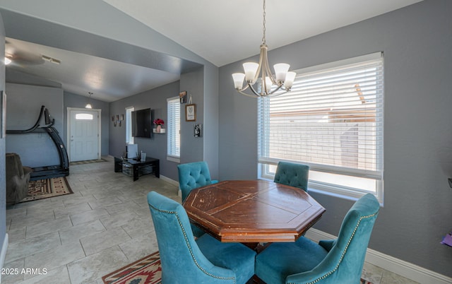 dining space with an inviting chandelier and vaulted ceiling