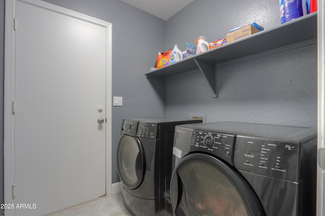 laundry area featuring light tile patterned floors and independent washer and dryer