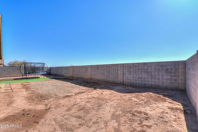 5175 W Warren Dr, Casa Grande, AZ 85194 - view of yard with a trampoline and a fenced backyard