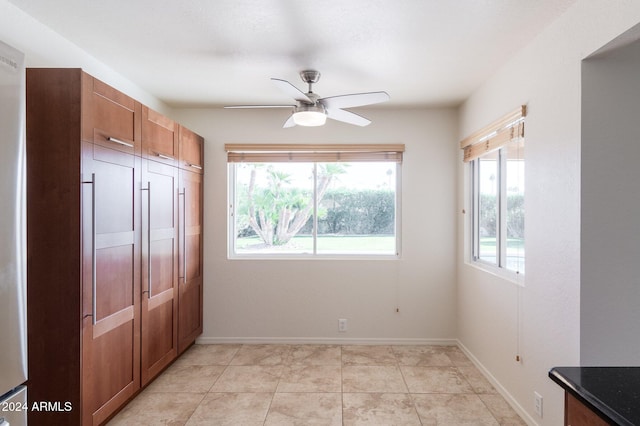 interior space with ceiling fan and light tile patterned floors