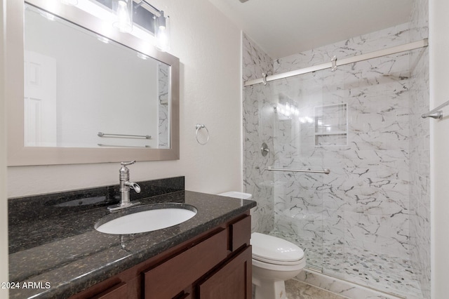 bathroom with vanity, toilet, and a shower with door