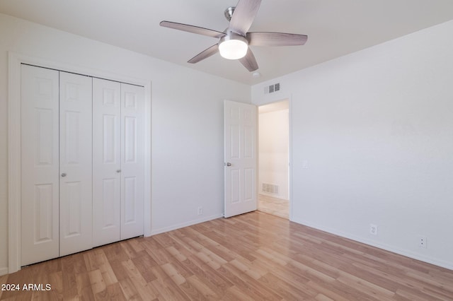 unfurnished bedroom featuring ceiling fan, a closet, and light hardwood / wood-style floors