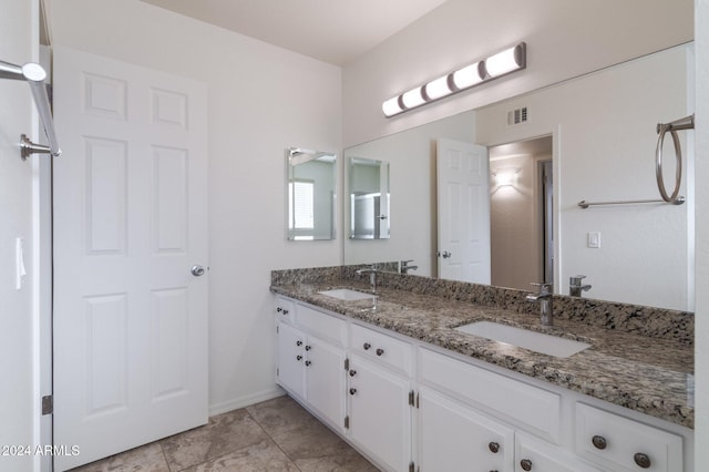 bathroom with tile patterned floors and vanity