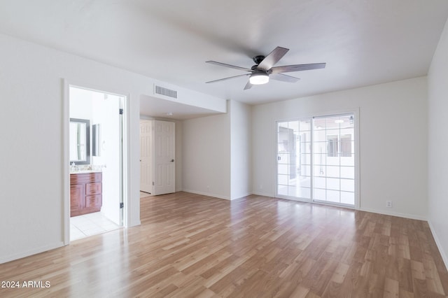 spare room with ceiling fan and light wood-type flooring