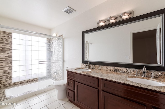 full bathroom featuring shower / bath combination with glass door, tile patterned floors, vanity, and toilet