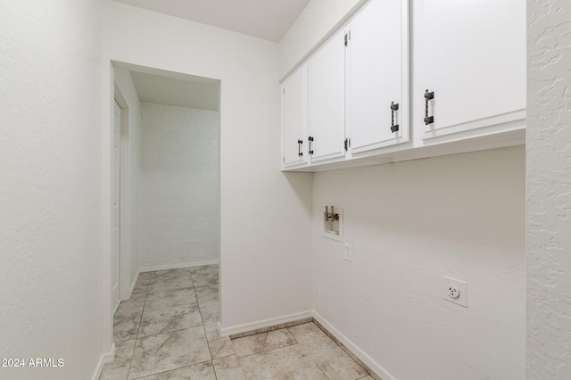 laundry room featuring electric dryer hookup and cabinets