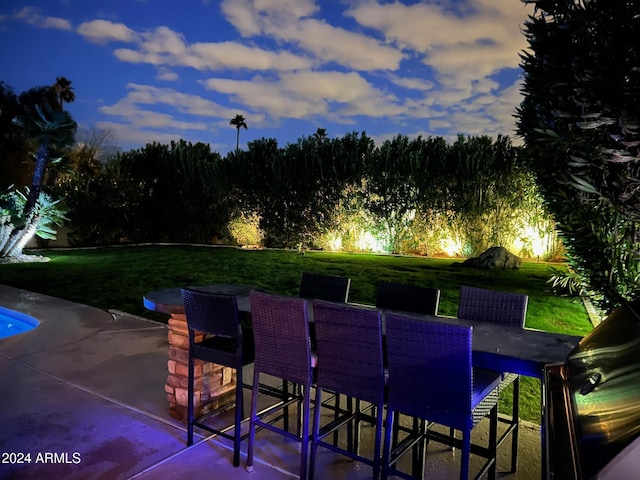 patio terrace at dusk with a lawn