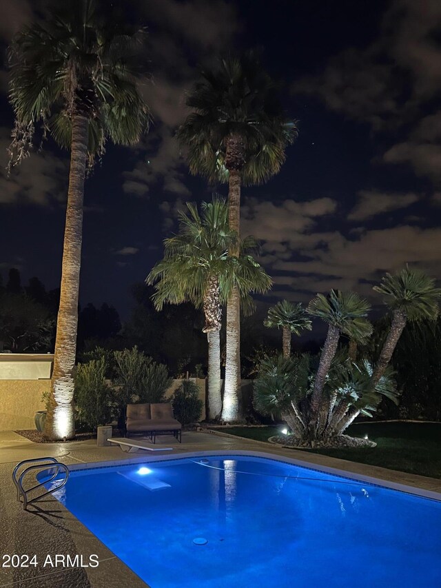 view of pool at night