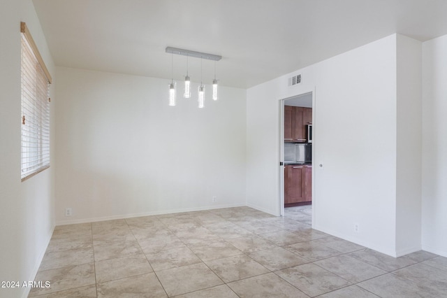 unfurnished room with light tile patterned floors